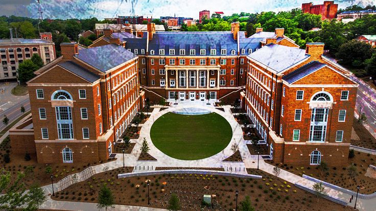 a large building with a circular lawn